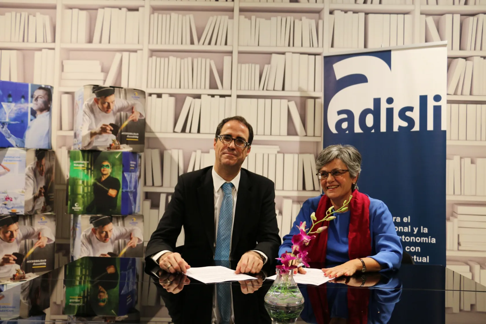 Firma de convenio por ll director de RRHH de ILUNION Hotels, Juan José Cestero y la presidenta de ADISLI, Belén Meyer 