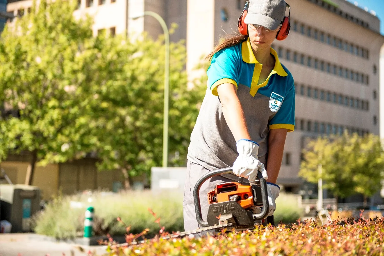 Trabajadora de ILUNION Facility Services realizando funciones de jardinería 